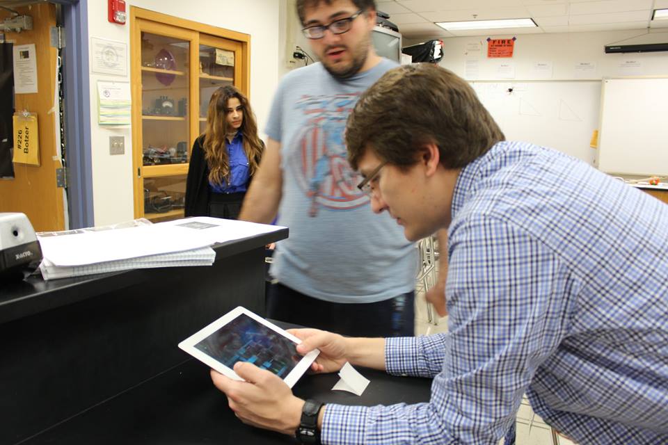 Partner teacher Mr. Botzer plays our game at yet another 7AM Trinity High School playtest.