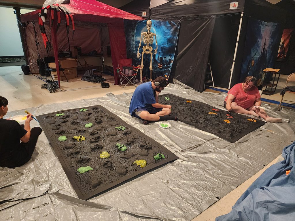 Members of Stage and Steel painting props for the Halloween festival