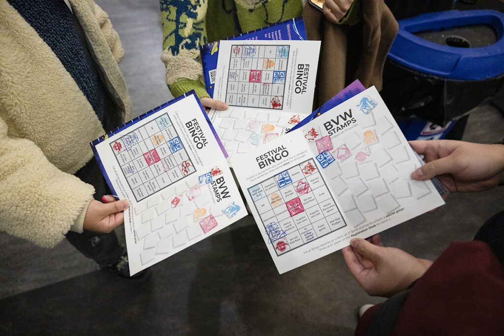 Guests show off their Festival “passport” at the end of the evening, stamped by each project they visited 