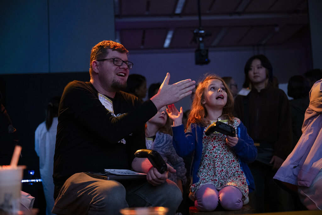 ETC Assistant Teaching Professor Jonathan Walton plays a student-made game with his daughter