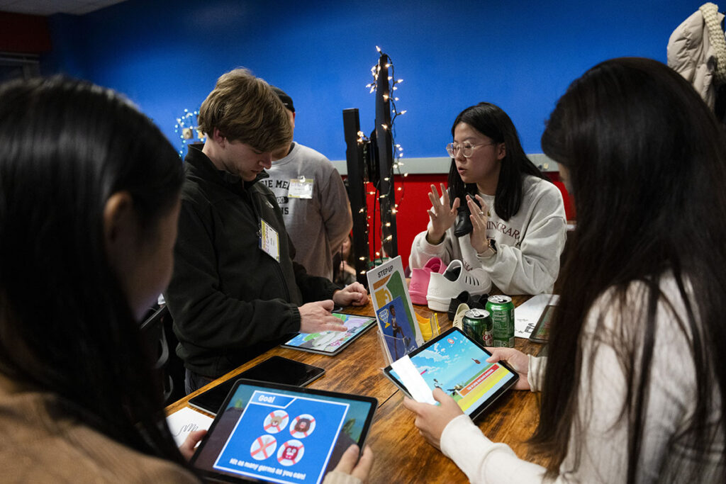 Eva Chang instructing guests on how to play the game at ETC’s Fall Festival