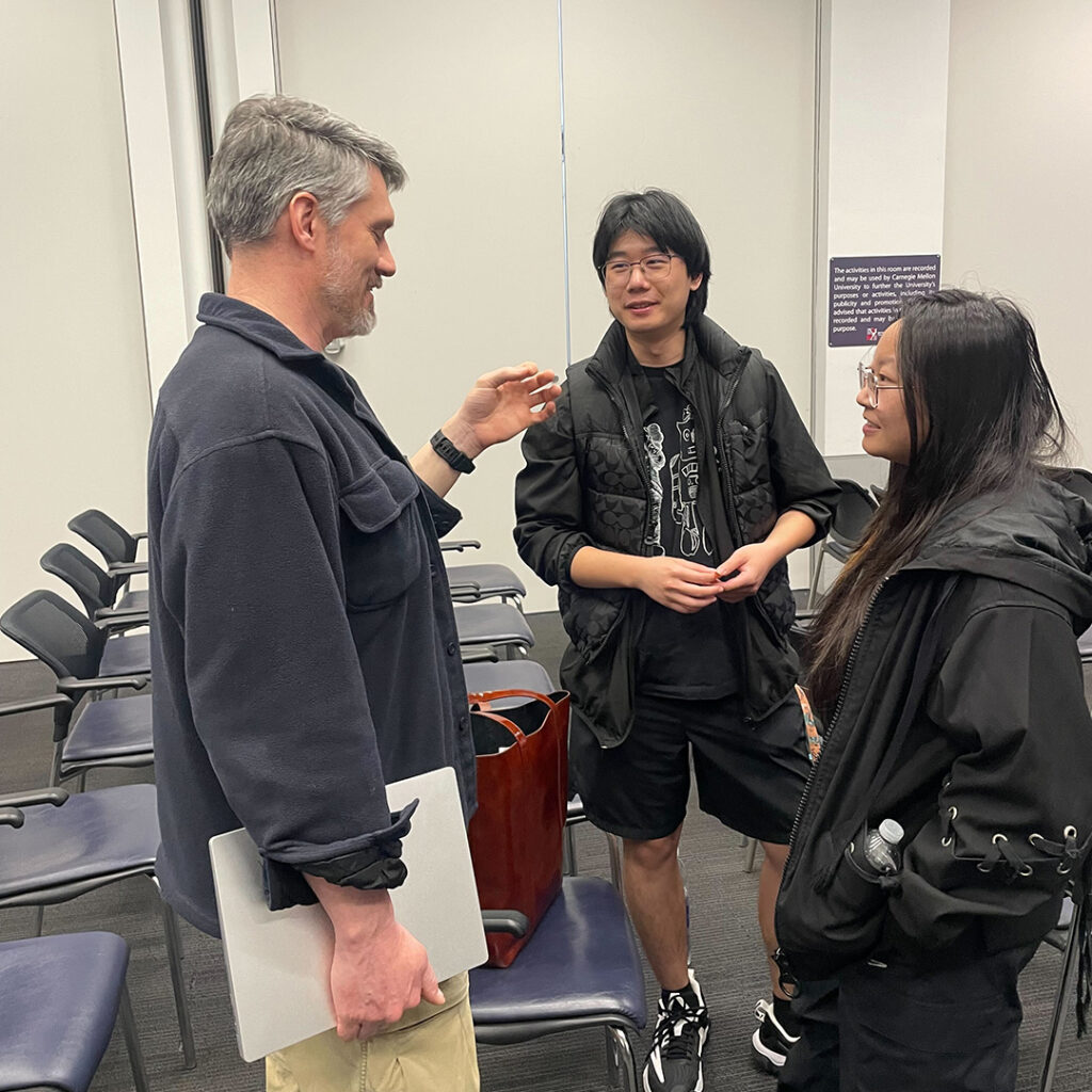 ETC Director of Information Technology Steve Audia speaks with current ETC students at the post-event reception.