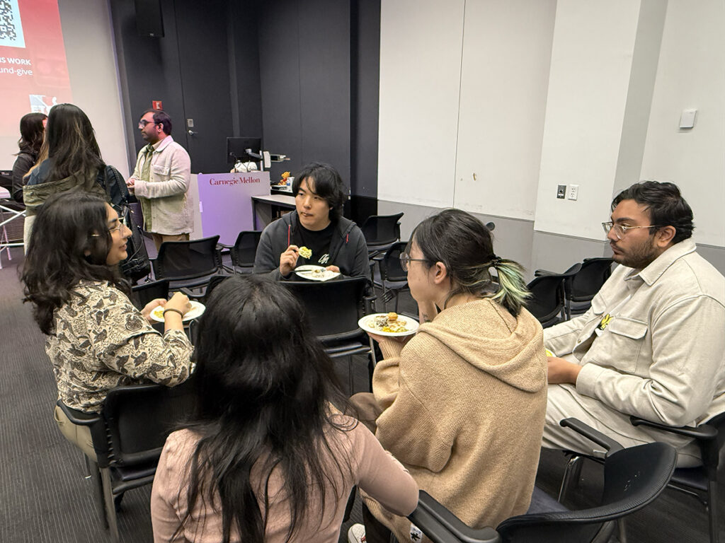 Current ETC students talking with each other after the event