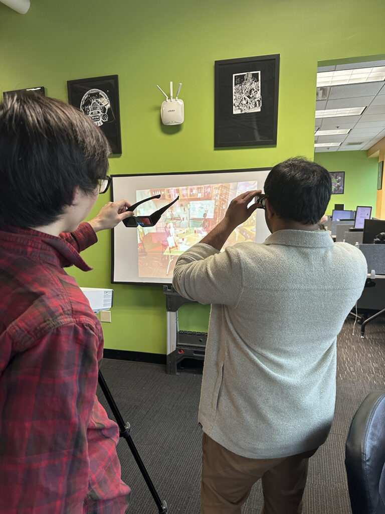 Sawant playtests Colleido, an animation project that leverages Duel Eye Point technology, with first-year student and project team member Dennis Sun.