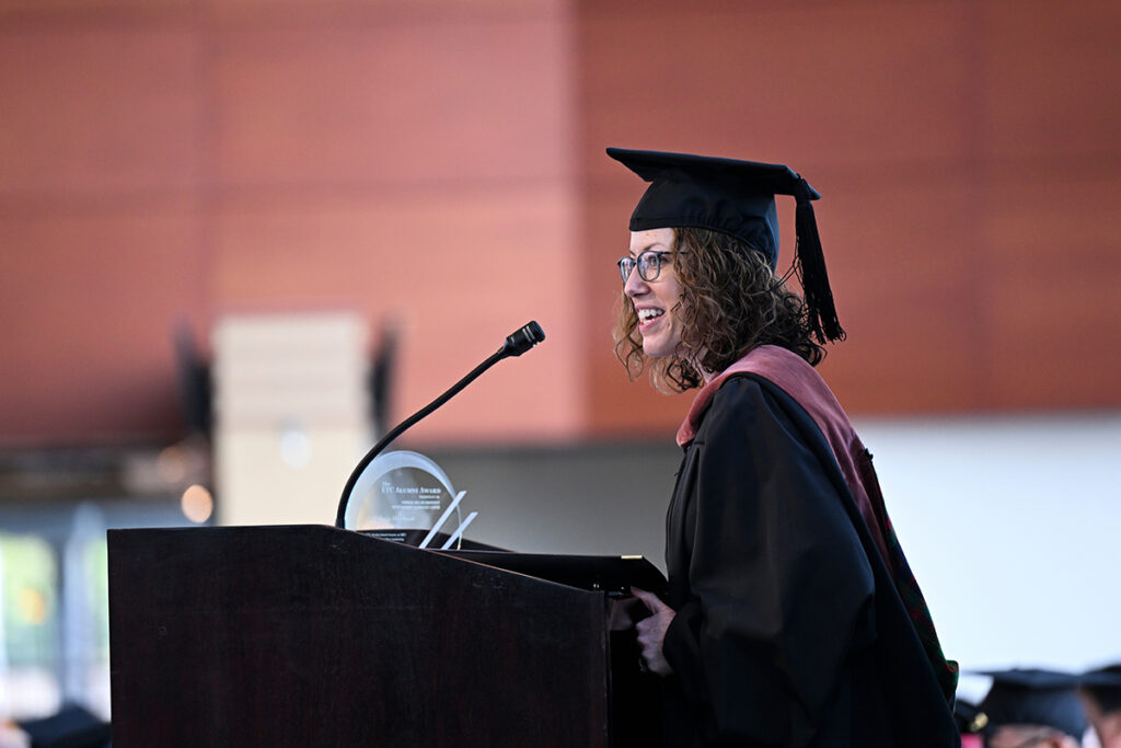 2025 Alumni Award winner Estefania Harbuck addressing the outgoing class